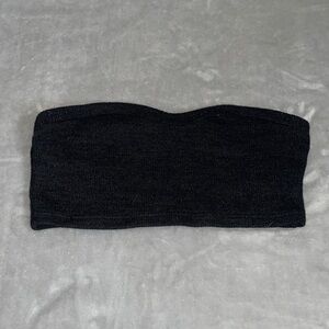 Knit fabric, linty tube top but comfortable and soft.